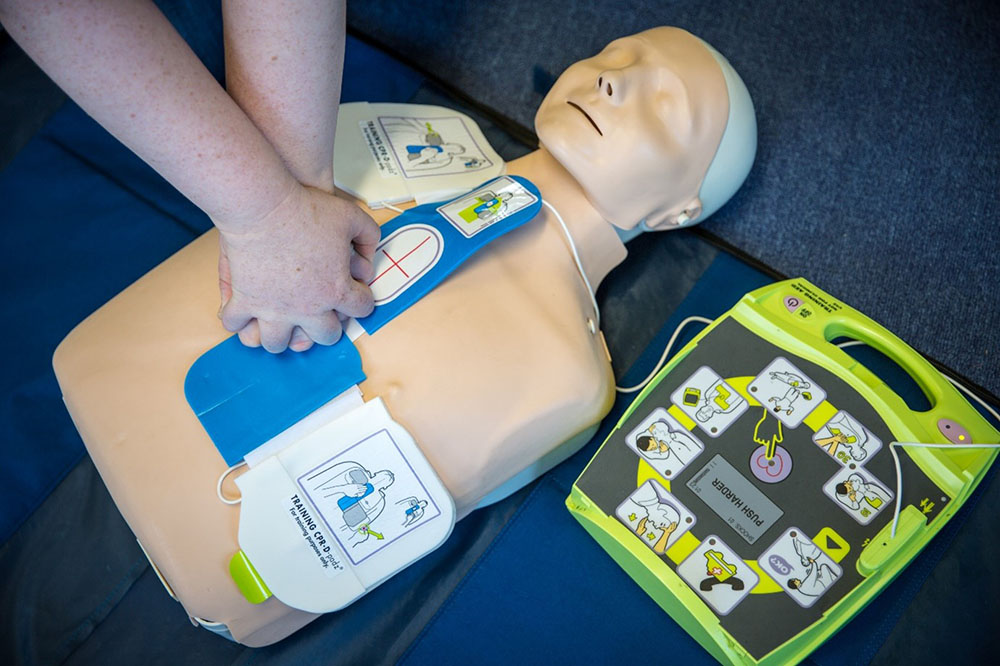 A person using a training defibrillator.