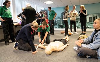 A group of people learning in a first aid class.